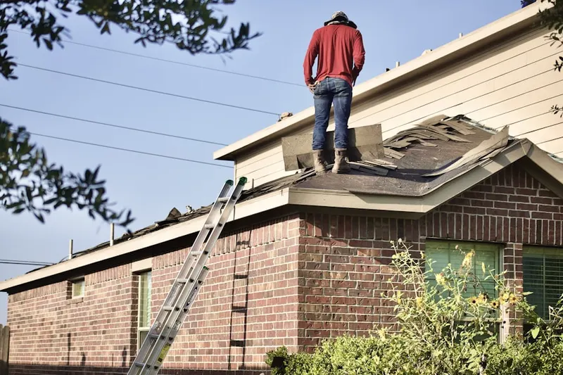 Professional roofer working on a residential roof in Horsehead